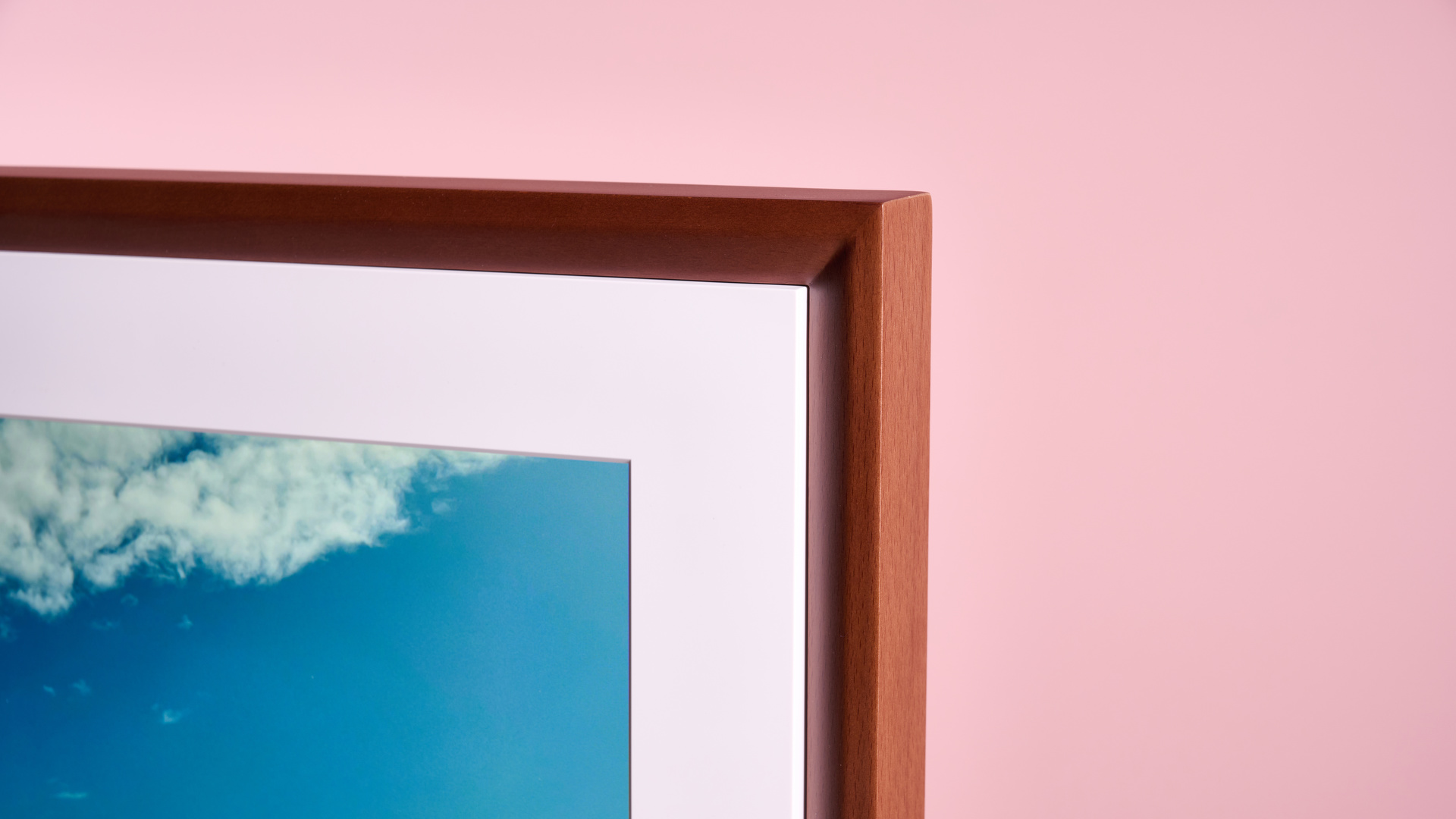 The wood effect frame and white mount of Netgear Meural Canvas II.
