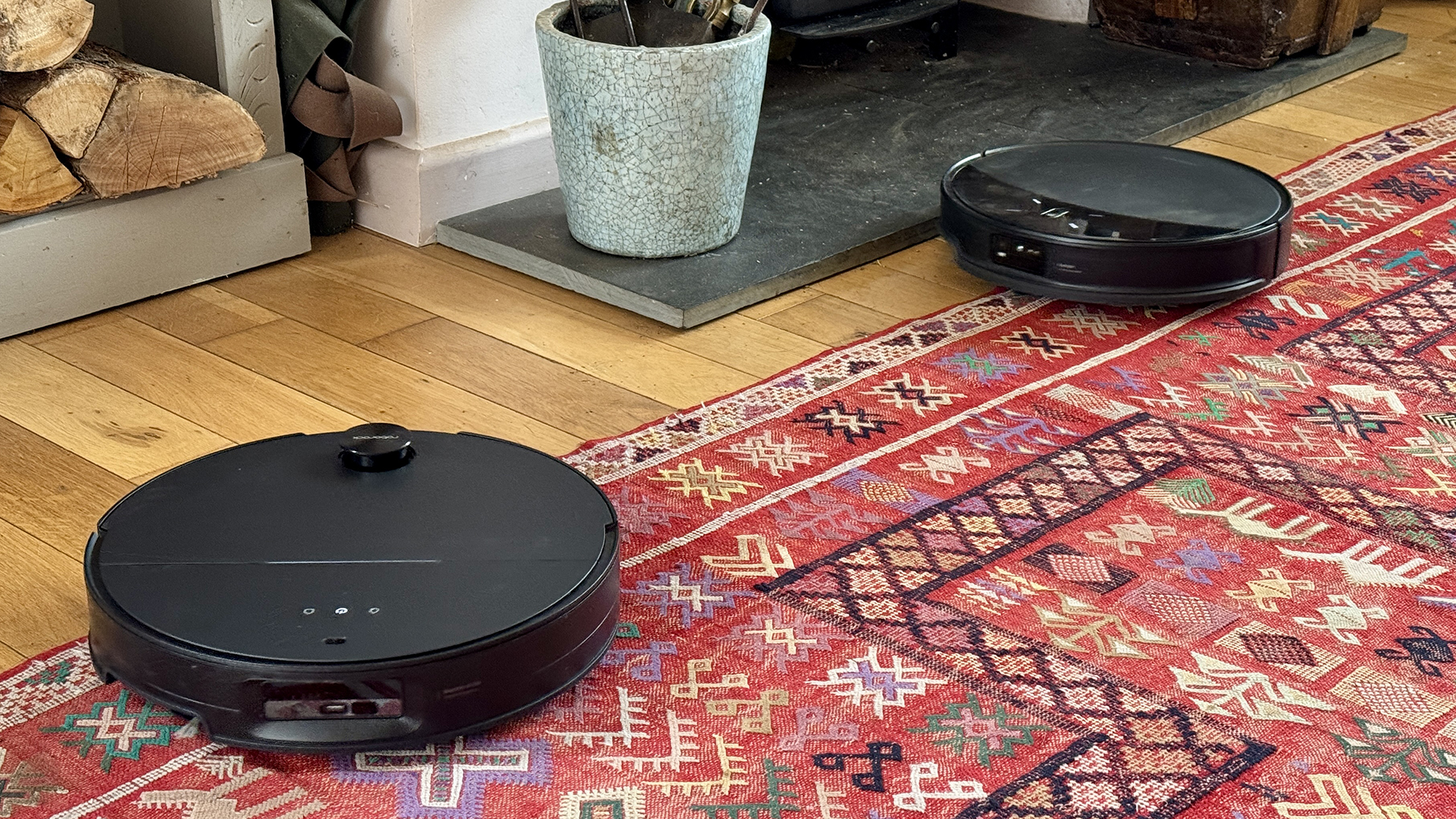 Roborock Saros 10R and Saros 10 robot vacuums side by side in reviewer's house