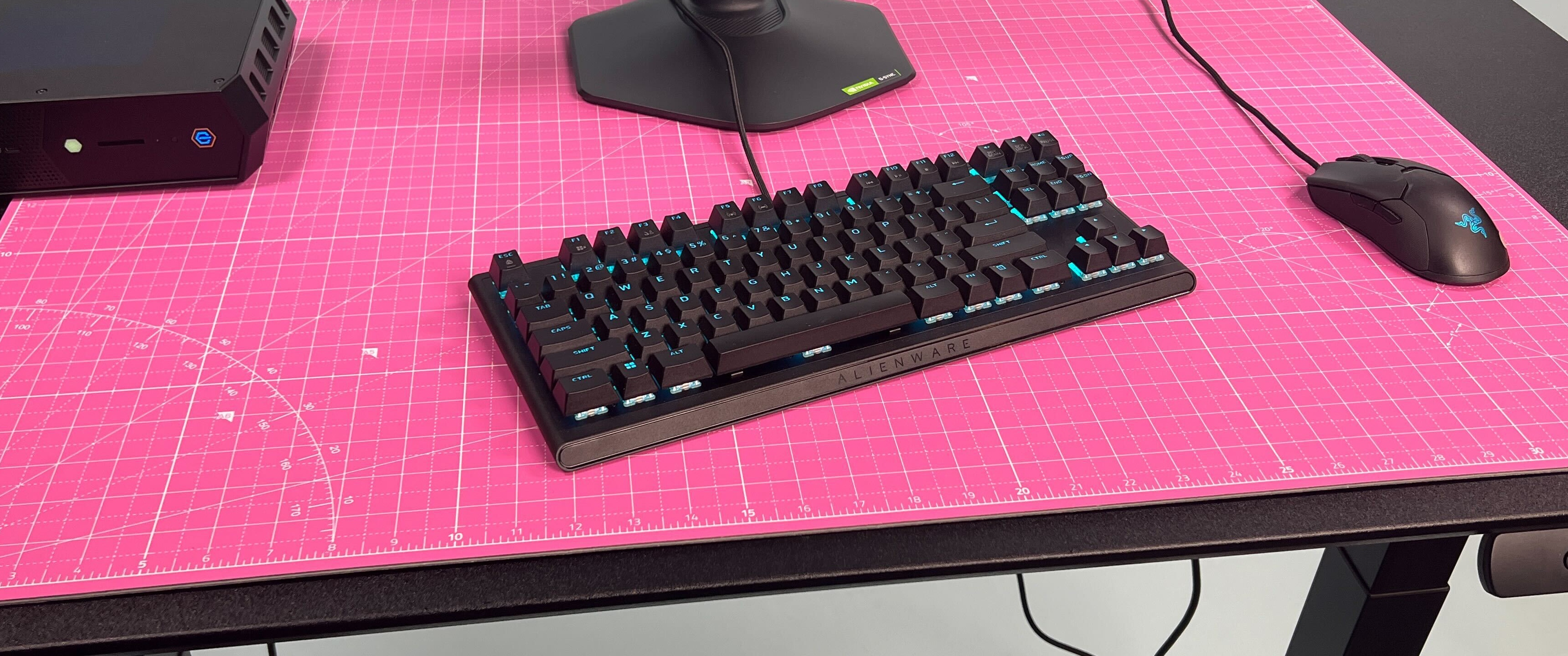a black keyboard sitting on a pink mat