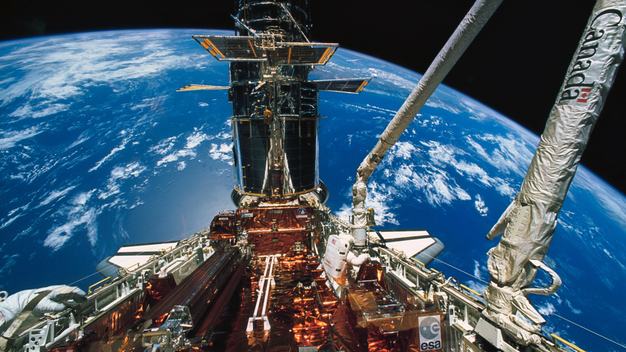 NASA astronaut Story Musgrave moves about in space shuttle Endeavour&#039;s cargo bay during the deployment of the solar array panels on the Hubble Space Telescope during the final of five STS-61 spacewalks, on Dec. 9, 1993. 