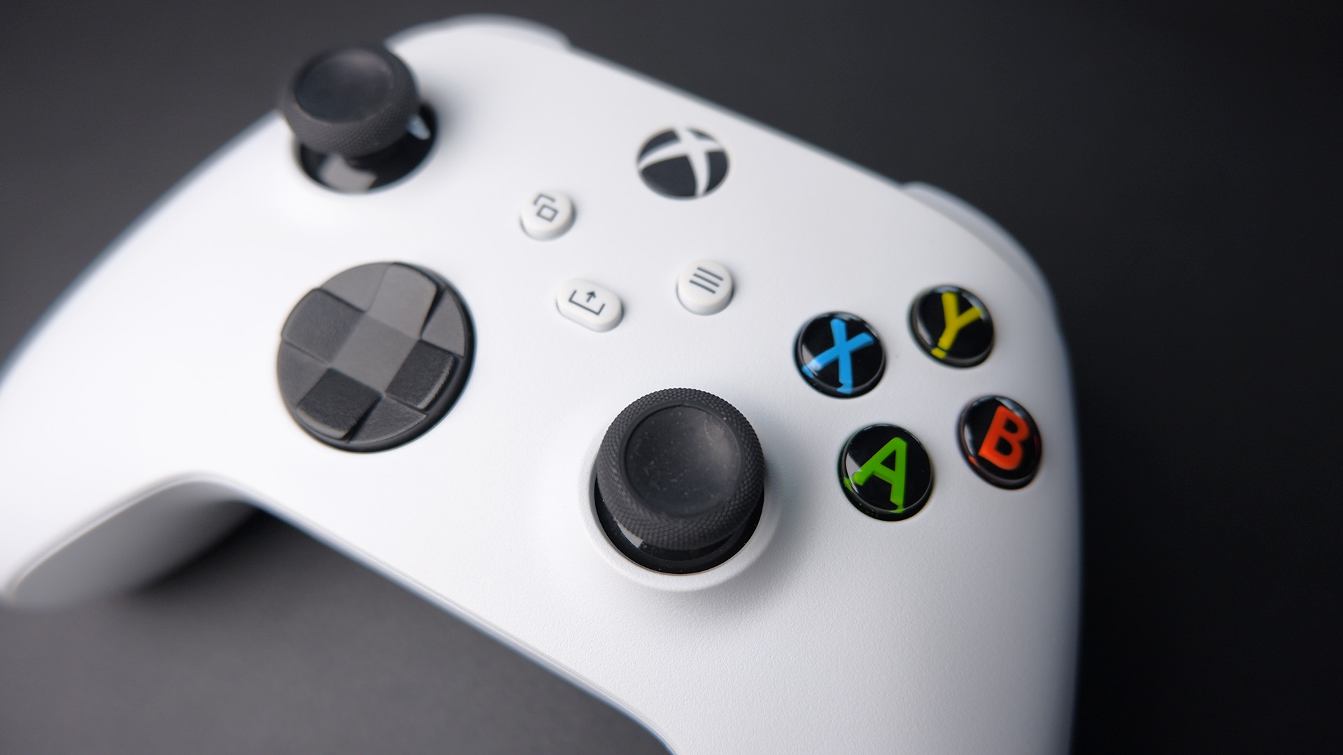 The Xbox Wireless Controller in white sat on a desk.