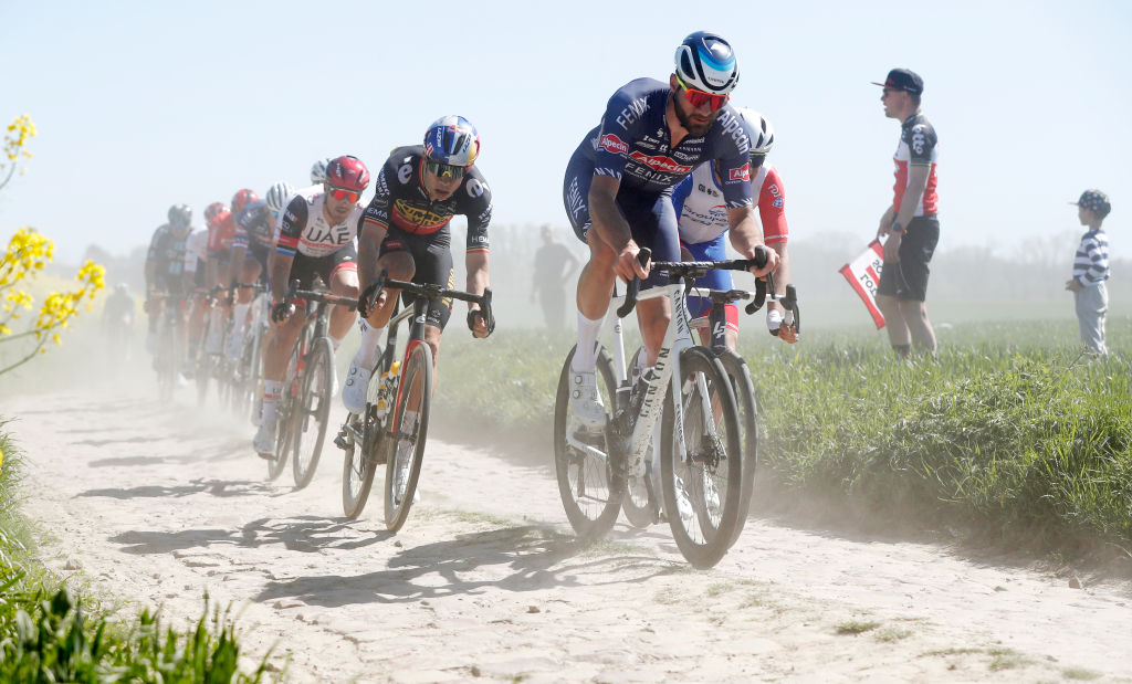 ROUBAIX FRANCE APRIL 17 LR Wout Van Aert of Belgium and Team Jumbo Visma and Guillaume Van Keirsbulck of Belgium and Team AlpecinFenix compete passing through a cobblestones sector during the 119th ParisRoubaix 2022 Mens Elite a 2572km one day race from Compigne to Roubaix ParisRoubaix WorldTour on April 17 2022 in Roubaix France Photo by Bas CzerwinskiGetty Images