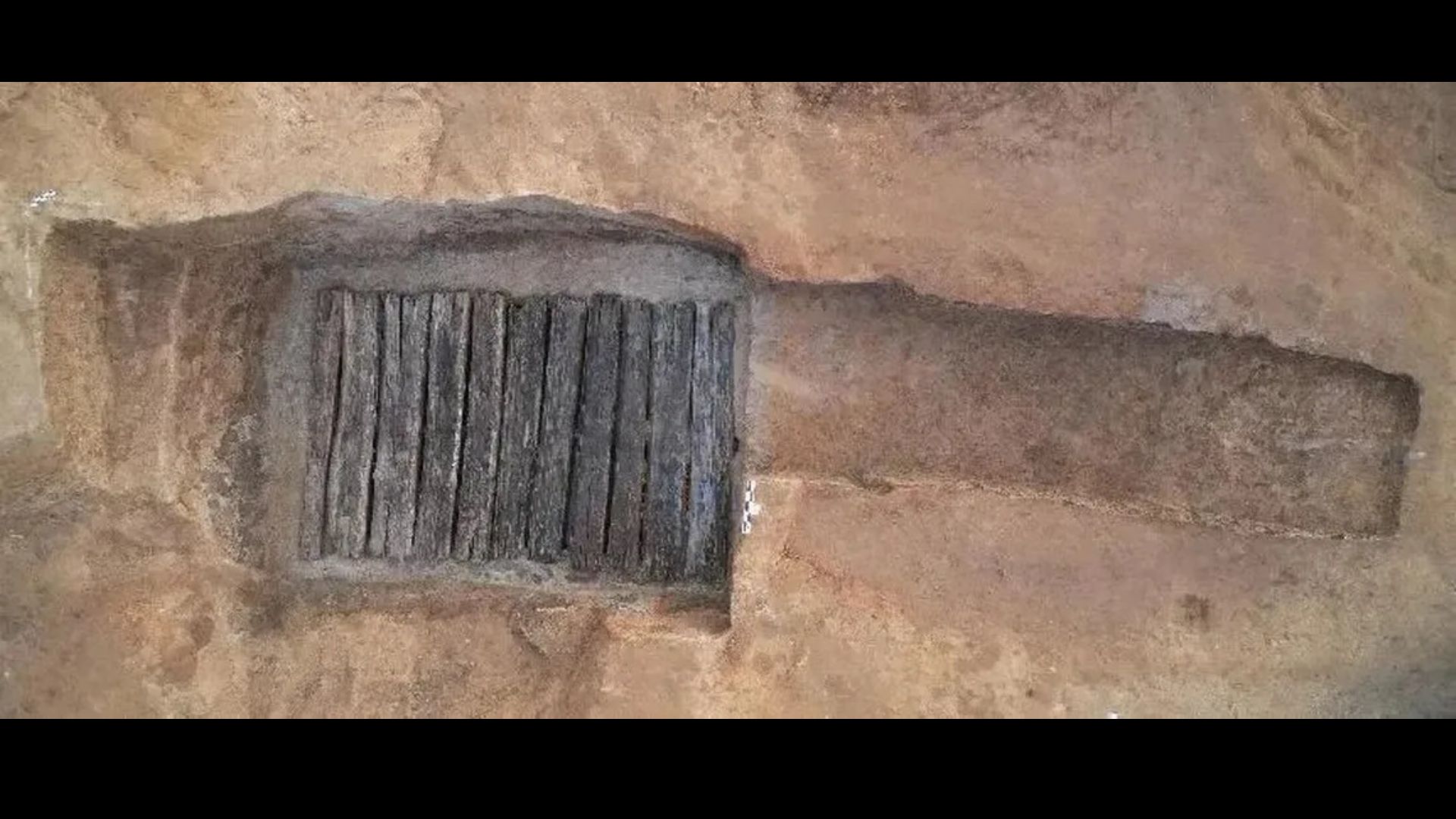 The untouched tomb has a traditional Chinese "knife" shape and is about 22 feet long, with a paved "tomb road" sloping down to a tomb door.
