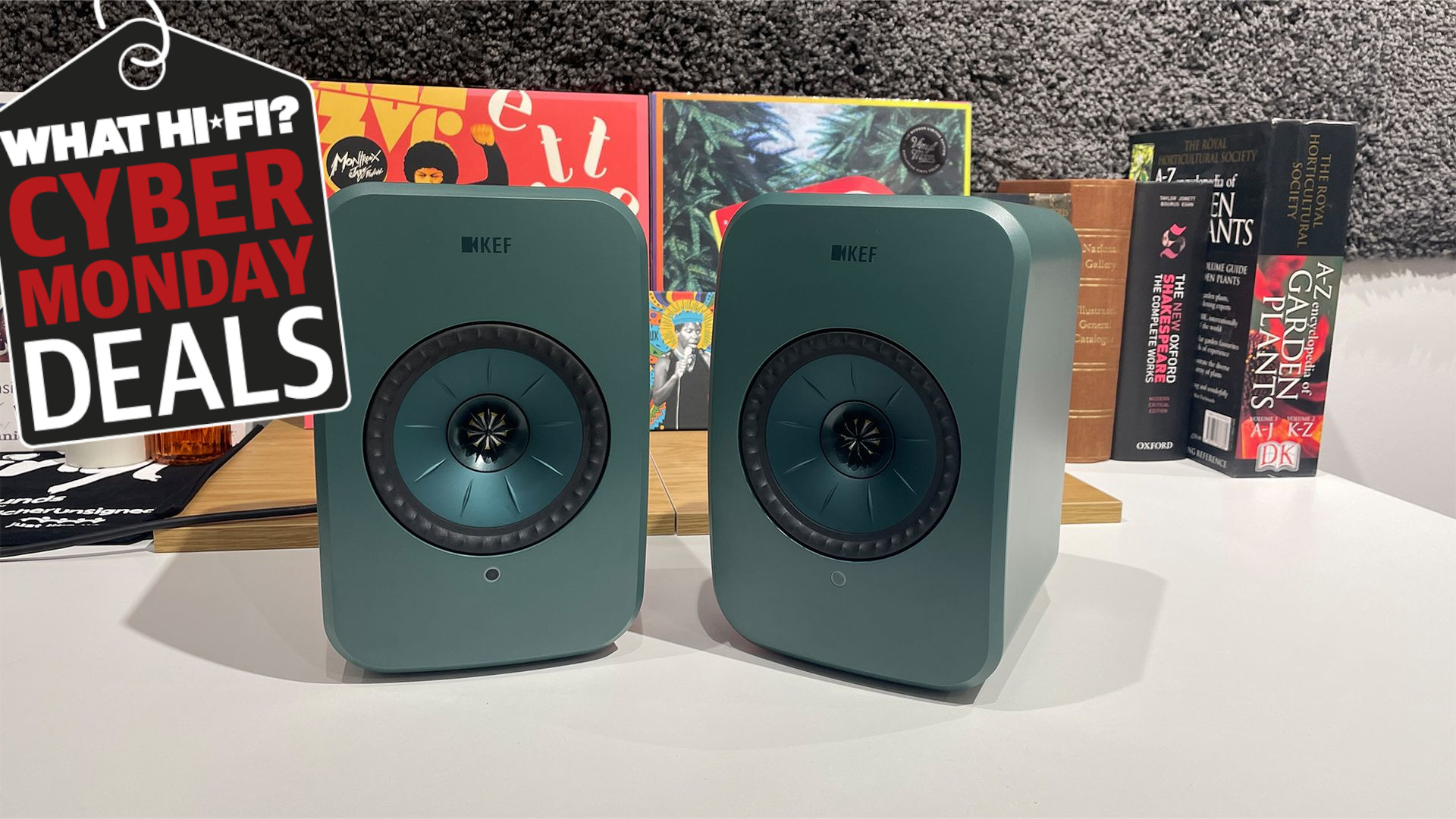 KEF LSX II LT wireless speakers on a desk with a Cyber Monday tag