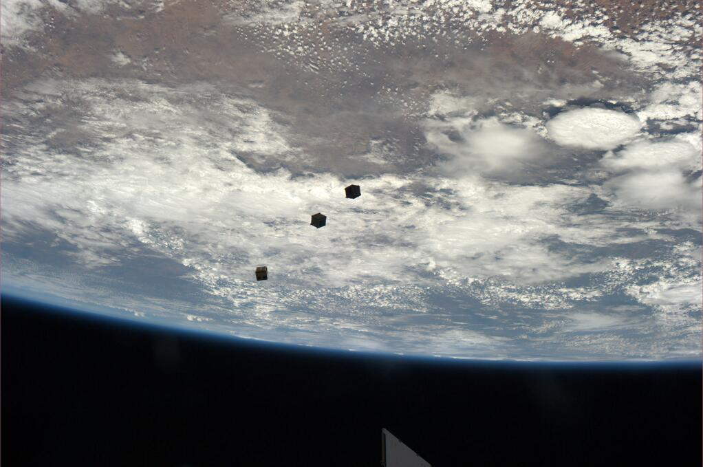 Three small cubesats float above the Earth after deployment from the International Space Station. Astronaut Rick Mastracchio tweeted the photo from the station on Nov. 19, 2013.