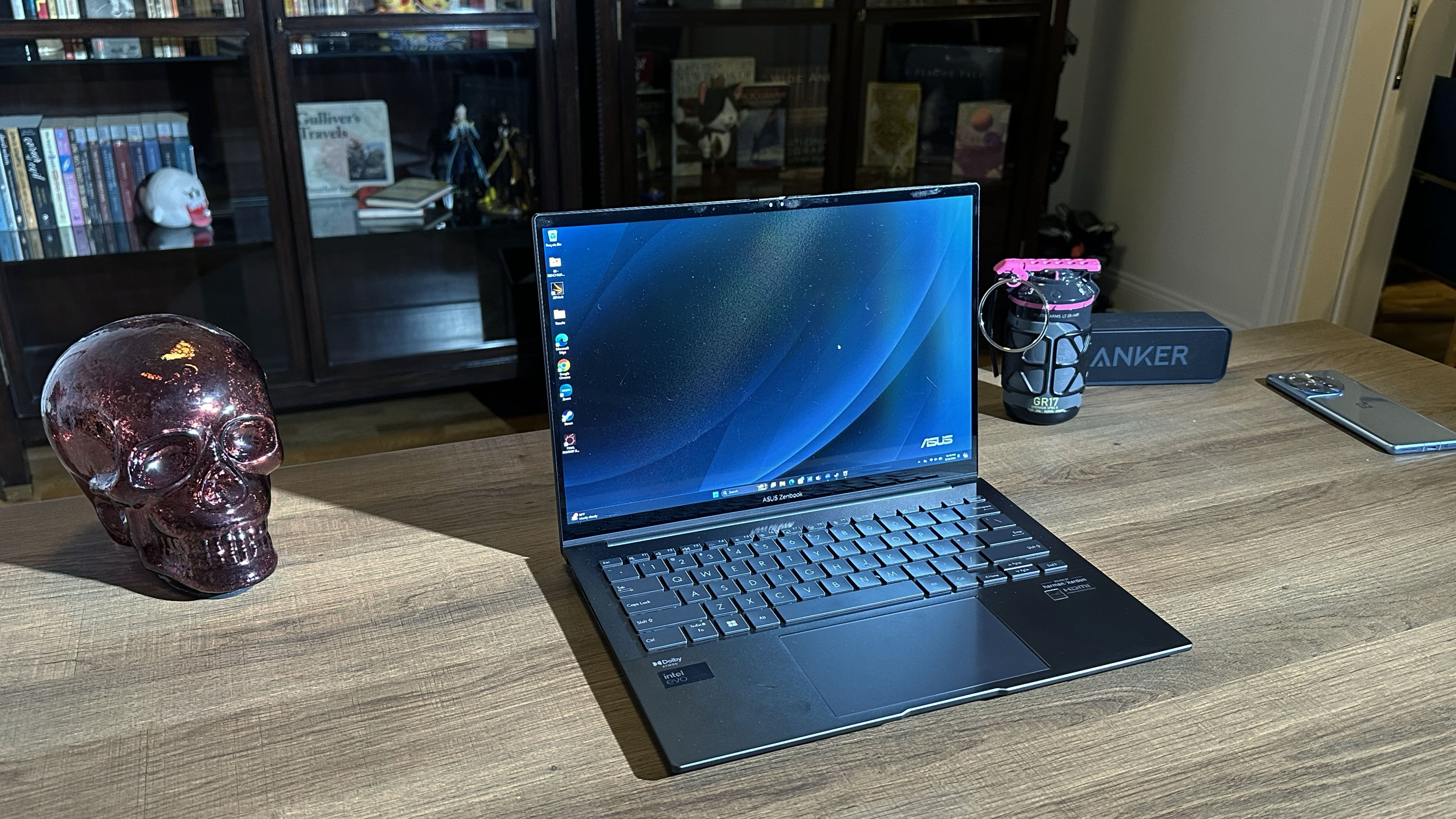 Asus Zenbook 14 OLED (Q425M) open on a wooden desk with the display facing the camera showing how well it handles bright environments