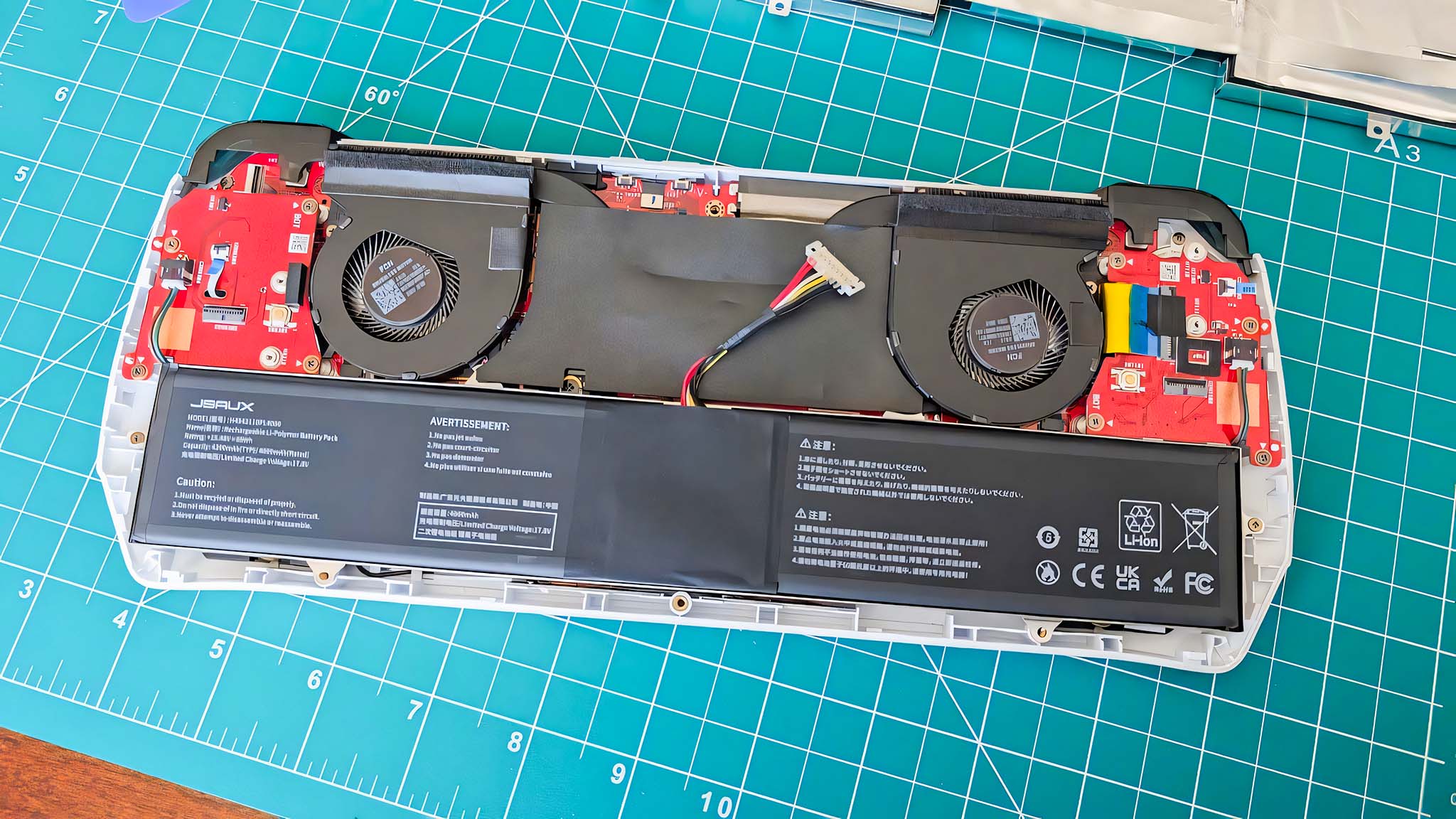 The battery from the JSAUX ROG Ally Battery Upgrade Kit installed in the open Ally, but without the ribbon on top.