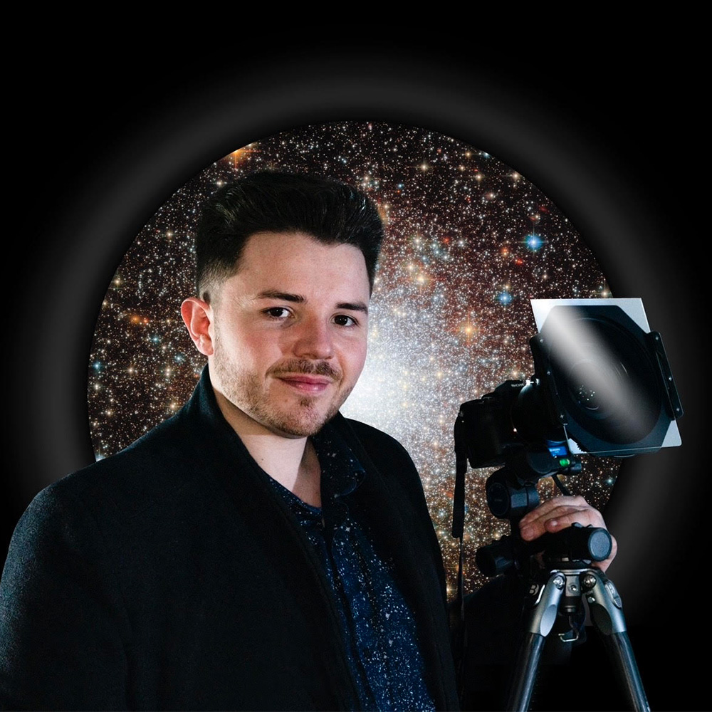 Contributing expert Josh Dury with a camera against a black starry background