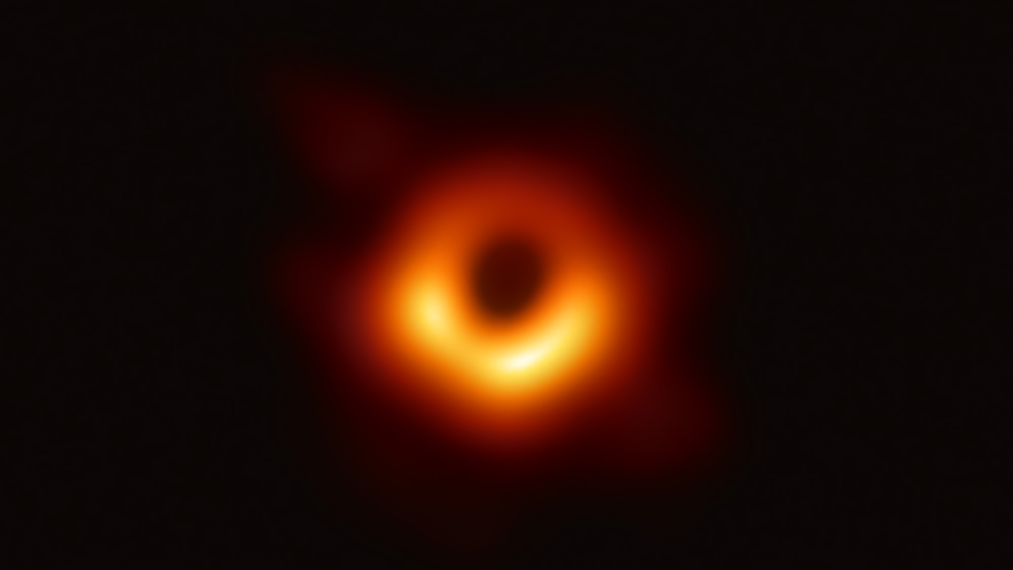 A glowing orange ring with a dark center and a brighter yellow lower third.