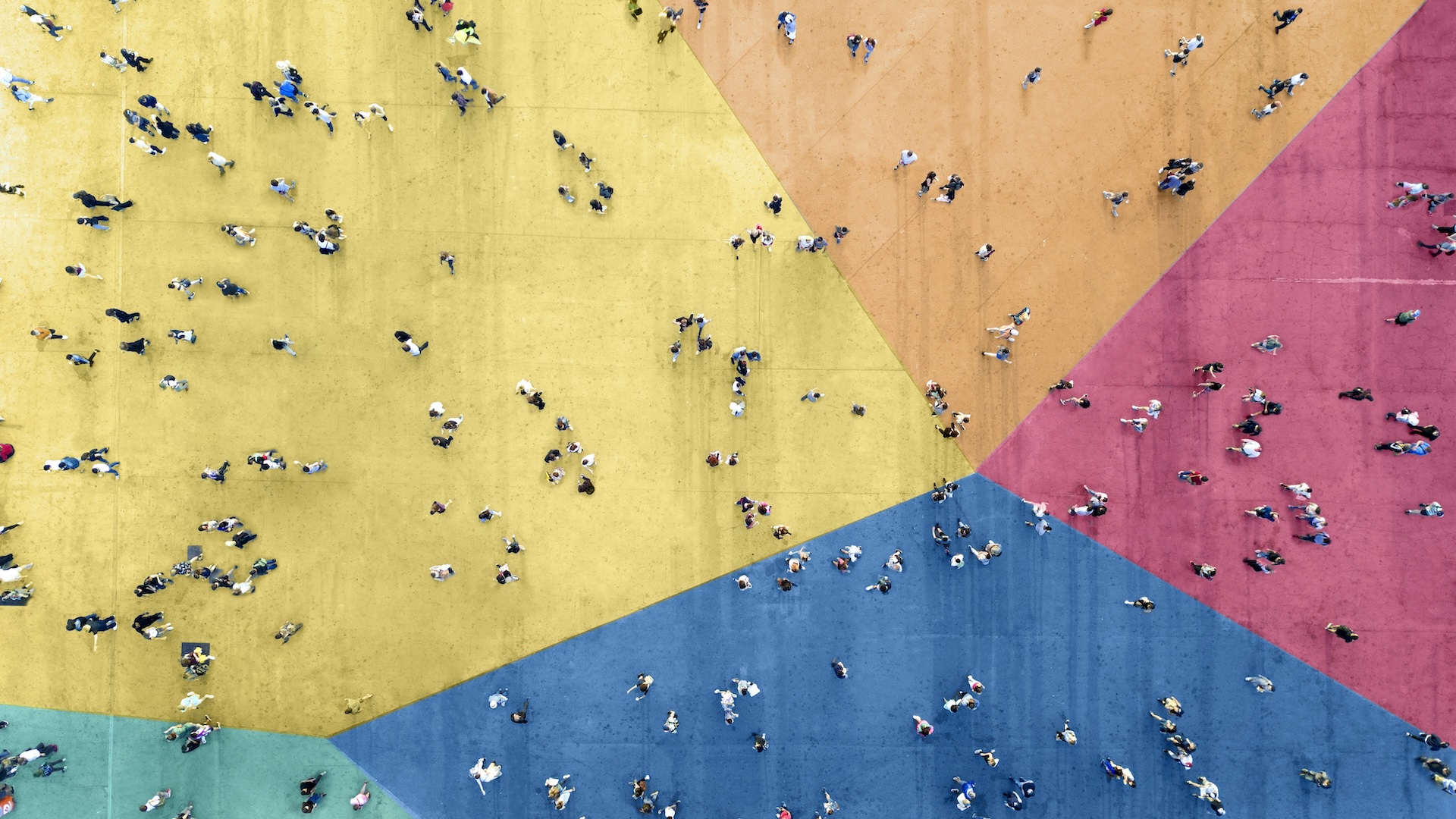 a bird&#039;s eye view of a crowd of people on a multicolored floor